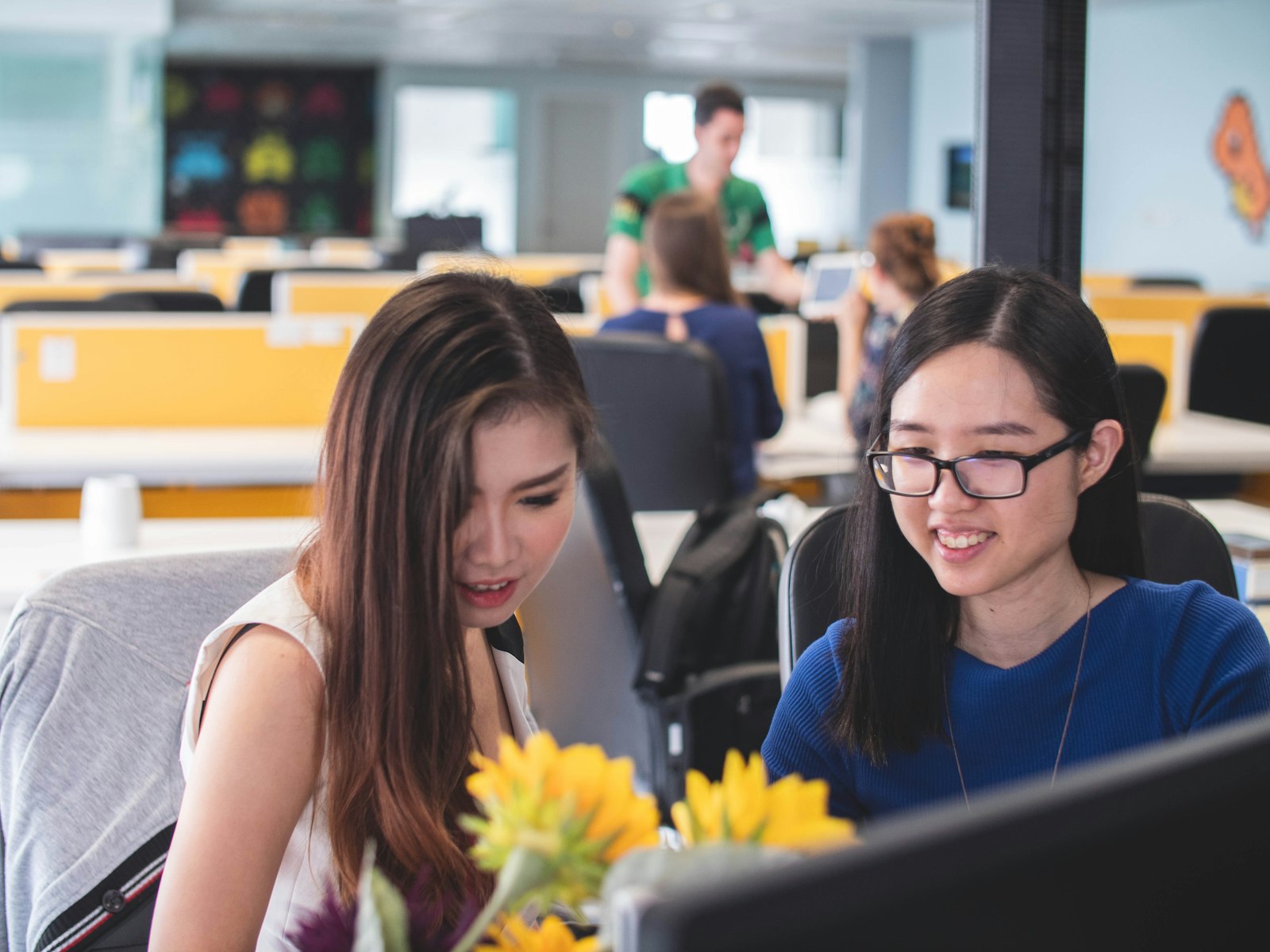 Two members of the Manila team working together
